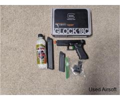 Green gas airsoft Glock 18c with holster and optic.